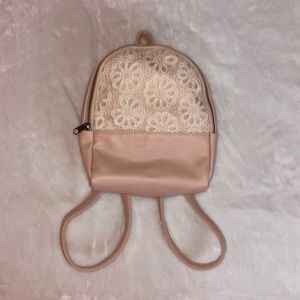A light pink mini backpack